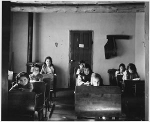 old photo of children sitting in a classroom